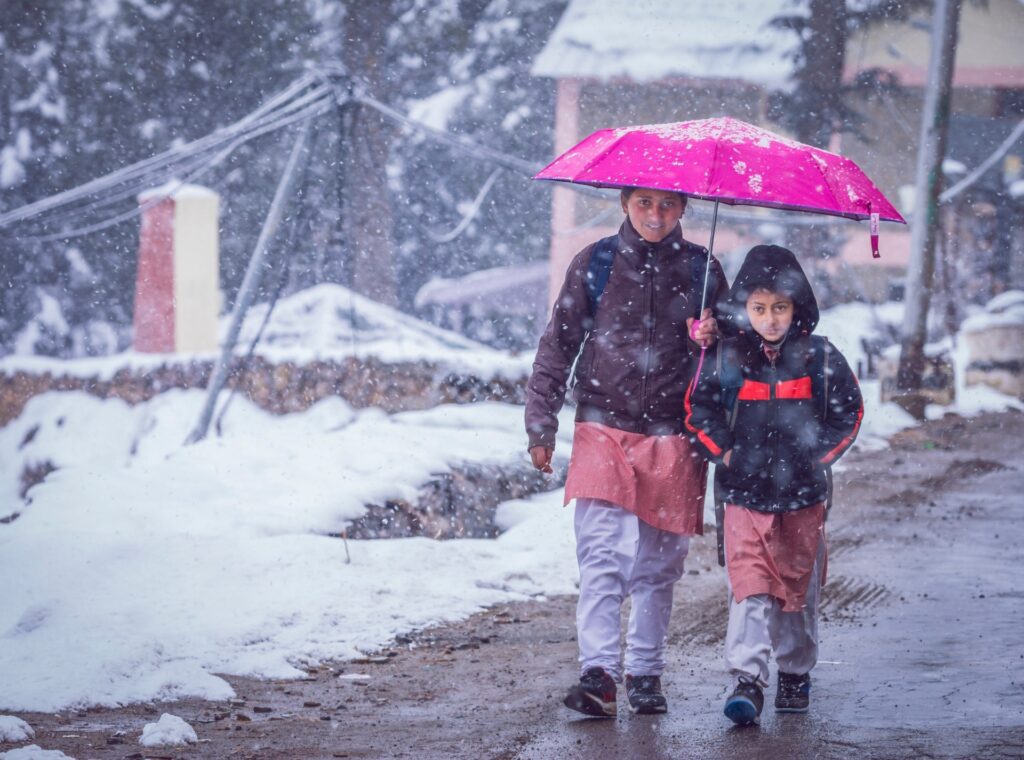 Children going to school in rainy weather